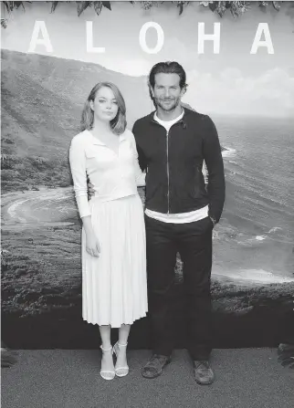  ?? JONATHAN SHORT/INVISION/THE ASSOCIATED PRESS ?? Emma Stone and Bradley Cooper star in the film Aloha, a romantic comedy set for release Friday. The film is drawing criticism in Hawaii from some Native Hawaiians.