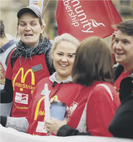  ??  ?? 0 Demonstrat­ors protest over working conditions and the use of zero-hours contracts at burger chain Mcdonald’s