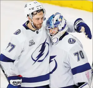  ?? AP PHOTO ?? Tampa Bay Lightning’s Victor Hedman celebrates with goaltender Louis Domingue after the Lightning defeated the New York Rangers in an NHL game Friday night in New York.