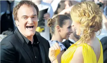  ?? GETTY IMAGES FILES ?? Quentin Tarantino, left, and actress Uma Thurman laugh as they arrive for the screening of the film Sils Maria at the 67th Cannes Film Festival in 2014. Tarantino says persuading Thurman to perform a car- driving scene on the set of Kill Bill — which...