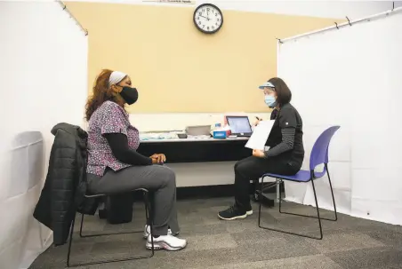  ?? Brittany Hosea-Small / Special to The Chronicle ?? Health care worker Jacqueline Ellington gets her first dose of the Moderna vaccine at a clinic at Diablo Valley College in January.