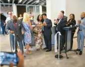  ?? ?? Council member Lisa Lucas-Burke and Dr. Johnny Garcia, surrounded by city officials, celebrate Bloom Coworking’s grand opening/ribbon-cutting Monday in Portsmouth.