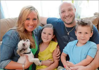  ?? TIM COOK/THE DAY ?? The Guarraia family, from left, Amie, Julianne, 8, Matt and Anthony, 3, with Safari, the family dog, July 16 at their home in East Lyme.