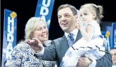  ?? ERNEST DOROSZUK/POSTMEDIA NETWORK ?? Ontario Conservati­ve Leader Tim Hudak is joined by his daughter Miller, 3, and wife Deb Hutton after delivering the keynote address at the Ontario PC convention held at the Toronto Congress Centre on May 28, 2011.
