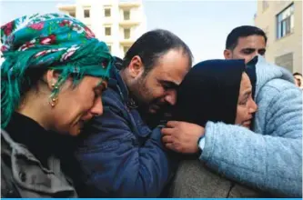  ??  ?? AFRIN, Syria: A picture taken in the town of Afrin shows the mother (center), brother (2nd left) and sister (left) of the late 23-year-old YPJ fighter Barin Kobani, attending a mourning ceremony in her honor, after the YPJ and the Syrian Observator­y...