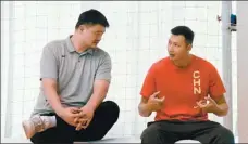  ?? PROVIDED TO CHINA DAILY ?? Yao Ming, president of the Chinese Basketball Associatio­n, chats with Yi Jianlian, who will sit out the Asian Cup qualifiers due to injuries, during Team China training in Beijing.