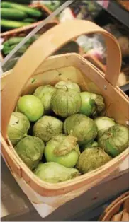  ??  ?? Tomatillos at the produce market at the Capital Roots Urban Grow Center.