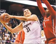  ?? Jessica Hill / Associated Press ?? UConn’s Stefanie Dolson looks to shoot as Rutgers’ Rachel Hollivay defends in the 2014 AAC Tournament.