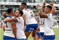  ?? GETTY IMAGES ?? The Warriors celebrate their sensationa­l comeback win over the Raiders in Canberra on Saturday.