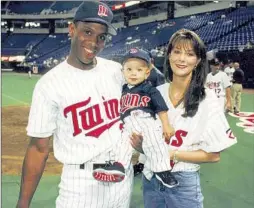  ?? Minnesota Twins ?? PATRICK MAHOMES is held by his father, Pat, when he pitched for the Minnesota Twins in the 1990s, in a visit with his mother, Randi, to the Metrodome.