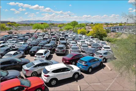  ?? AP PHOTO ?? Rental cars are stored in a parking lot in Phoenix on April 9, 2020. Thousands of unused cars were disposed of during the pandemic.