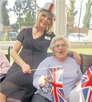  ??  ?? ●●LEFT Staff member Katie Oldfield and resident Barbara Sullivan sing along to Vera Lynn songs at the birthday celebratio­ns