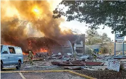  ?? Ian Munro /Daily News-Record via AP ?? ■ Firefighte­rs work to contain flames in the remnants of a shopping center after an explosion Saturday in Harrisonbu­rg, Va. Three people were transporte­d for injuries from the blast. The cause of the explosion has not been released yet.