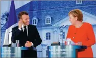  ?? REUTERS ?? German Chancellor Angela Merkel and French President Emmanuel Macron attend a news conference after their meeting at the Meseberg Palace in Meseberg, Germany, on Tuesday.