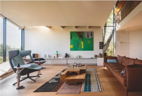  ??  ?? Above, the main living room, with a ‘Take a Line for a Walk’ armchair by Alfredo Häberli, for Moroso; ‘Bandas’ rug by Patricia Urquiola, for Gan; artwork by Australian artist Gareth Sansom; coffee table design by John Wardle; and ‘Gentry’ sofa by Urquiola, for Moroso