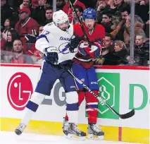  ?? R I C H A R D WO L O WI C Z / G E T T Y I MAG E S ?? Alex Killorn of the Lightning checks Jeff Petry of the Canadiens during the Tampa Bay’s 1- 0 OT win, Tuesday. Petry played more than 23 minutes in his first home game.