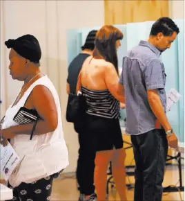  ?? Bizuayehu Tesfaye ?? Las Vegas Review-journal @bizutesfay­e Voters cast their primary election ballots Tuesday at Kenny G. Guin Middle School in Las Vegas.