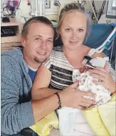  ?? COURTESY: ALFIE GRAY ?? Alfie Gray and his partnerJen­n McCall hold their daughter Tinnley for the first time on Sunday. She and her twin brother Vincent were born three months premature and are at the Hospital for Sick Children. A GoFundMe campaign has been launched to help them.