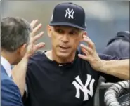  ?? KATHY WILLENS — ASSOCIATED PRESS ?? Yankees manager Joe Girardi gestures as he talks to an unidentifi­ed man before Sunday’s game against the Indians.