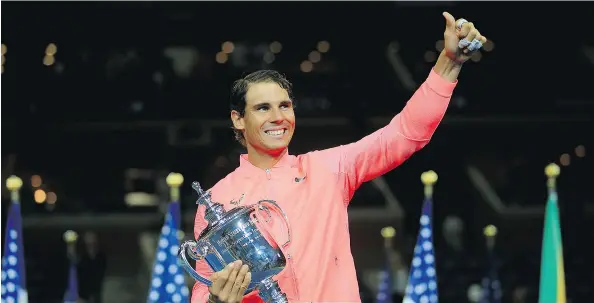  ?? CHRIS TROTMAN / GETTY IMAGES FOR USTA ?? Rafael Nadal poses with the championsh­ip trophy after winning the U. S. Open in New York on Sunday.
