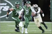  ?? BILL KOSTROUN - THE ASSOCIATED PRESS ?? New York Jets quarterbac­k Zach Wilson, center, tries to avoid being tackled during the second half of an NFL football game against the New Orleans Saints, Sunday, Dec. 12, 2021, in East Rutherford, N.J.