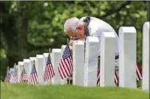  ?? JOHN SPINK / JSPINK@AJC.COM. ?? Dale Covington of Marietta, a Vietnam veteran, prays at the end of Maj. Gen. Joe Jarrard’s address at the 2017 Memorial Day Ceremony at the Marietta National Cemetery. This year’s event starts at noon May 28.