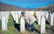  ?? AFP ?? A woman kisses a relative's grave at the memorial centre of Potocari, near the Bosnian city of Srebrenica.
