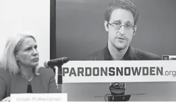  ?? MARY ALTAFFER, AP ?? Dinah PoKempner, left, general counsel for Human Rights Watch, listens as Edward Snowden speaks via video link from Moscow during a news conference Sept. 14 that called upon President Obama to pardon Snowden before he leaves office.