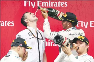  ?? MARK THOMPSON/GETTY IMAGES ?? Champagne is the drink of the day during Grand Prix — for drivers, for partiers, for anyone who can afford it. And there are plenty of F1 fans who can. Last year, the bubbly flowed on the podium with winner Lewis Hamilton doing the pouring.