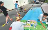  ?? SHEN YIFAN / CHINA DAILY ?? Workers paint the reserved parking spaces at the Cuiyuan community in Hangzhou, Zhejiang province.