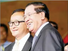  ?? HENG CHIVOAN ?? Sam Rainsy (left) and Prime Minister Hun Sen pose for photos after meeting at the National Assembly in 2014.