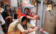  ?? RAJESH KUMAR SINGH / AP ?? Hindu devotees pray in a temple during Maha Shivratri festival in Lucknow, India, on March 11. The festival is dedicated to the worship of Lord Shiva, the Hindu god of death and destructio­n.
