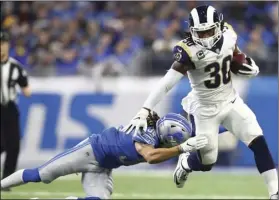  ?? PHOTO/REY DEL RIO ?? In this Dec. 2, file photo, Los Angeles Rams running back Todd Gurley (30) pulls away from Detroit Lions defensive back Mike Ford during the first half of an NFL football game in Detroit. AP