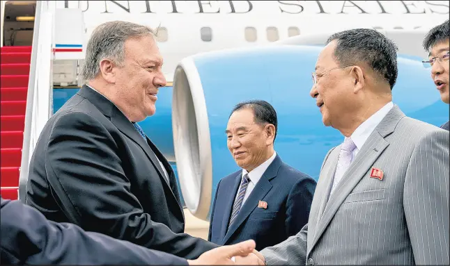 ?? ANDREW HARNIK/AP ?? U.S. Secretary of State Mike Pompeo, left, shakes hands with North Korean Foreign Minister Ri Yong Ho on July 6 at Sunan Internatio­nal Airport in Pyongyang.