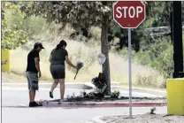  ?? PICTURE: AP ?? A couple visit a makeshift memorial in the parking lot of a Walmart store near where US authoritie­s discovered a trailer packed with Mexican and Central American immigrants, 10 of whom died, in San Antonio, Texas.