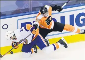  ?? FRANK GUNN — THE CANADIAN PRESS VIA AP ?? Flyers center Tyler Pitlick (18) checks New York Islanders defenseman Scott Mayfield (24) during the third period of second round payoff game earlier this week. The two teams will have to wait to play Game 3 after the league announced it is postponing the next two days of competitio­n amid protests against racial injustice.