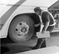  ??  ?? Tyres of an express bus being checked by a JPJ officer.