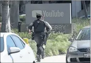  ?? JEFF CHIU — THE ASSOCIATED PRESS ?? Officers run toward a YouTube office in San Bruno Tuesday in response to an active shooter situation at YouTube HQ.