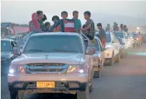  ?? | HUSSEIN MALLA/AP ?? Fleeing Iraqi citizens wait in a queue to cross to secure areas at a Kurdish security forces checkpoint on Wednesday.