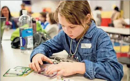  ?? / RCS ?? Rome City Schools student Laura Scott gives her project one more look before presenting it at Rome City Schools’ second annual Tech Fair.