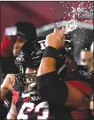  ?? Canadian Press photo ?? Ottawa Redblacks offensive lineman Jon Gott (63) smashes a beer can on his helmet after chugging it during second half CFL football action in Ottawa on Friday.