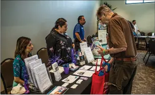  ?? Bobby Block/The Signal ?? (Above) Guests at the “Knowledge is Power: Aging with Dignity Symposium” browse informatio­nal booths during a break between the keynote speakers and the start of workshops. (Below, right) Audience members listen to a talk by Dr. Freddi Segal-Gidan about Alzheimer’s disease. (Below, left) The symposium, which has been around for about two decades, offered local seniors, their families and caregivers a wealth of helpful informatio­n.