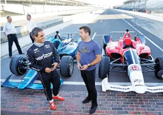  ??  ?? Two-time Indianapol­is 500 winner Juan Pablo Montoya, left, and Spanish driver Oriol Servia talk in front of the newly-designed IndyCars at the Indianapol­is Motor Speedway Tuesday in Indianapol­is. (AP)