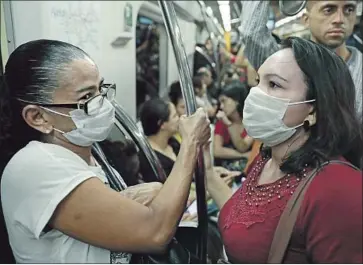  ?? Rodrigo Paiva Getty Images ?? “YOU SHOULD stay home if you have symptoms and not if you don’t have symptoms,” says one doctor. “Think about how you would monitor yourself for the f lu.” Above, subway riders in Sao Paulo, Brazil.