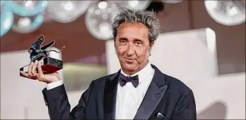  ?? Associated Press photo ?? Paolo Sorrentino holds the Silver Lion Grand Jury Prize for ‘The Hand Of God’ after the closing ceremony of the 78th edition of the Venice Film Festival in Venice, Italy, on Saturday.