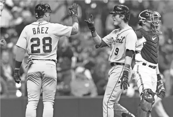  ?? JEFF HANISCH/USA TODAY SPORTS ?? Tigers third baseman Nick Maton, right, is congratula­ted by shortstop Javier Báez after hitting a home run during the third inning against the Brewers on Monday in Milwaukee.