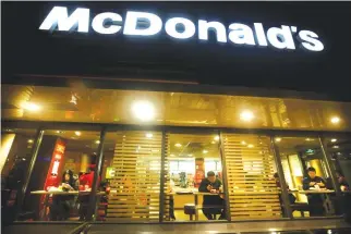  ??  ?? CUSTOMERS eat dinner at a McDonald’s store in Beijing, China Jan. 9.