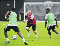  ?? — GETTY IMAGES FILES ?? DC United player Wayne Rooney, centre, takes part in a training session at the Robert F. Kennedy Memorial Stadium training field.