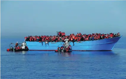  ?? Darrin Zammit Lupi / Reuters ?? Migrants are rescued by Migrant Offshore Aid Station in the central Mediterran­ean off the coast of Libya.