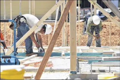  ?? KENT D. JOHNSON / KDJOHNSON@AJC.COM ?? Workers frame a home under constructi­on in Cumming in the spring. The jobless rate in Georgia’s constructi­on sector in June was 9.4 percent, the same rate as West Virginia, according to Associated Builders and Contractor­s. Only Mississipp­i’s rate of...